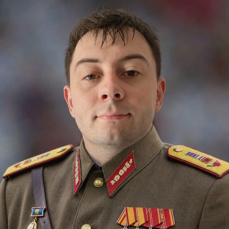 Alex Lalor in a decorated military dress uniform, straight-faced